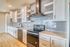 Modern kitchen with sleek cabinetry, stainless steel appliances, and stylish subway tile backsplash.