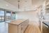 Modern open-concept kitchen with sleek cabinetry, spacious island, and large windows offering stunning views.