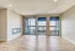 Bright and airy apartment living space with expansive floor-to-ceiling windows and modern fireplace.