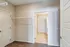 Spacious walk-in closet with elegant shelving, offering ample storage and easy access to adjoining room.