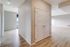 Bright apartment interior with elegant double doors, sleek wooden flooring, and a spacious layout promising modern comfort.