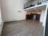 Modern loft apartment with high ceilings, open-plan kitchen with stainless steel appliances, and stylish wooden flooring.