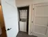 Modern compact laundry closet with stackable washer and dryer, featuring sleek white doors and efficient design.