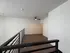 Modern loft space featuring sleek wood floors and a stylish ceiling fan, perfect for a cozy living area.