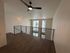 Modern loft space with sleek black railing, ceiling fan, and large windows for natural light.