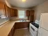 Charming kitchen with warm wooden cabinetry, ample counter space, and modern appliances, perfect for culinary adventures.