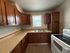Cozy kitchen with warm wooden cabinetry, modern countertops, and ample natural light.