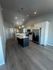 Modern kitchen with sleek stainless steel appliances, elegant pendant lighting, and a spacious island countertop.