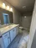 Elegant bathroom with sleek marble flooring, modern vanity, and spacious shower area.