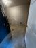 Spacious utility room with modern lighting, plumbing setup, and ample space for appliances.