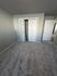 Bright and spacious room with plush carpeting, featuring a convenient double-door closet for ample storage.