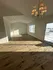 Bright and airy living space with elegant chandelier, natural hardwood floors, and large windows offering scenic views.