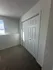 Bright corner with a double-door closet and natural light filtering through a window in a cozy room.