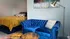 Cozy apartment nook featuring a plush blue velvet sofa and elegant decor with warm lighting.