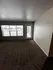 Bright and inviting living room with large windows offering scenic views and access to a private patio.