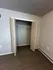 Spacious closet with double doors and plush carpet in a modern apartment.