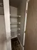 Contemporary closet with sleek wire shelving and modern tile flooring, maximizing efficient storage space.