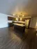 Modern kitchen with sleek dark wood cabinetry, granite countertops, stainless steel appliances, and an inviting island, perfect for culinary enthusiasts.