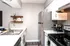 Contemporary kitchen with sleek stainless steel appliances, elegant shelving, and modern fixtures creating a stylish cooking space.