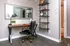 Chic home office with stylish desk, sleek black chair, and elegant open shelving adding modern flair.