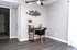 Chic home office corner with modern desk, stylish chair, and vibrant decor in bright, airy apartment.