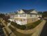 Image of community from corner of a townhome showing beautiful landscaping, sidewalks, and private fenced patios.