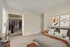 Model townhome showing second bedroom withs spacious closet and huge windows with room for a queen size bed and two night tables.
