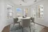 Dining area with dining table surrounded by windows and breathtaking views.