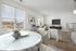 View from dining areas, surrounded by windows and leading into a spacious living area.