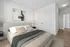 Alternate angle of bedroom showing queen bed and closet space.