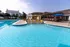 Overview of pool showing wading area with in-pool lounge chairs on right and lap pool on the left.