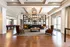Entrance to clubhouse and gathering area with armchairs, couches, and chandelier