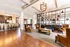 Gathering area in community clubhouse showing kitchen with barstool seating