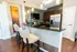 Clubhouse kitchen featuring island with seating and refrigerator, coffee maker, and microwave