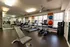 24-Hour Gym with elliptical trainer, weight bench and free weights, rower, and treadmills