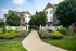 Beautifully landscaped garden apartment community with sidewalks and lush greenery