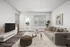 Stylishly furnished living room with a large window, modern decor, and cozy seating area.