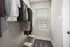 A stylish walk-in closet with modern clothing and accessories, featuring natural light from a window.