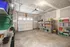 Neat garage with ample shelving for organized storage and a closed garage door.