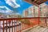 Inviting balcony overlooking vibrant plaza and stylish residential complex.