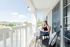 Resident Relaxing on the Balcony | Pflugerville  TX Apartment Homes | LC Plfugerville | New Albany OH Apartment For Rent | LC New Albany