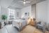 Modern bedroom with cozy ambiance, featuring a stylish bed with soft bedding, wooden nightstands, and a lush plant by a large window.