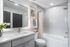 Elegant bathroom design with modern fixtures, luxurious white vanity, and stylish wall art.