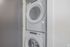 Modern stacked washer and dryer unit in a sleek laundry area, perfect for efficient apartment living.