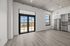 Bright modern apartment with sleek kitchen, stainless steel appliances, and large windows offering stunning patio views.