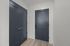 Modern entrance with sleek dark doors and elegant wooden flooring, providing a sophisticated welcome to your dream home.