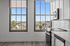 Bright and airy kitchen with modern appliances and stunning views through large windows overlooking a scenic landscape.
