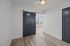 Chic apartment interior showcasing a sleek sliding door, elegant hardwood floors, and plenty of natural light through large windows.