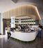 Modern coffee shop with stylish decor, featuring a curved counter, elegant lighting, and vibrant green accents providing a welcoming atmosphere.