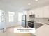 Bright and modern kitchen in The Select Collection at Annex West Townhomes, featuring sleek cabinetry and stainless steel appliances.